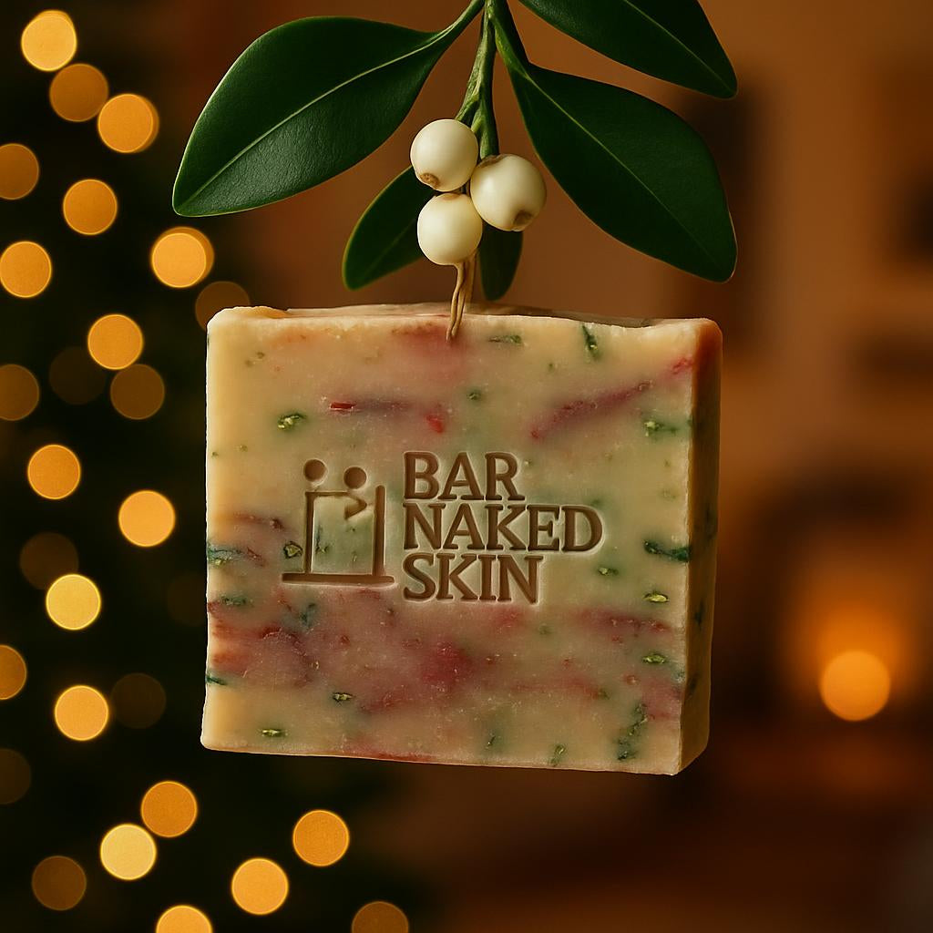 A close-up of a festive BAR NAKED SKIN mistletoe soap hanging in a warmly lit living room, with soft bokeh lights in the background, emphasizing the lush green leaves and white berries of the Merry Mistletoe.