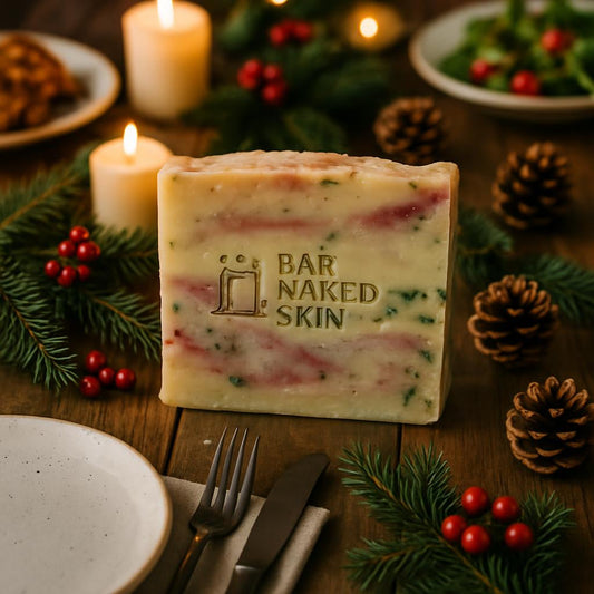 An overhead shot of the 'BAR NAKED SKIN' hanging above a rustic wooden table set for a holiday feast, with seasonal decorations and candles creating an inviting, festive dining scene.